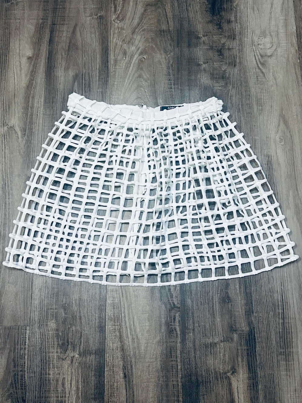 LF 1Z45 netted mini skirt features a caged, cut-out mesh design M